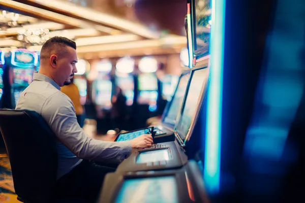 A young woman relaxing with her phone while dynamic casino elements float around her, illustrating the smooth mobile experience offered by the STARMAX88 app.